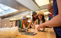 Apple flagship store, 5th Ave.  NYC. Three generations looking very interested.