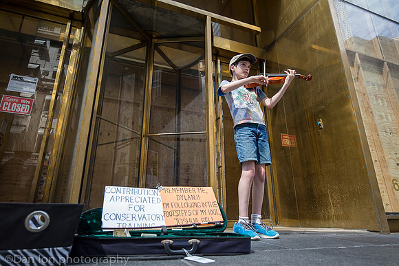 Young boy working hard playing the violin on 5th Ave., New York City